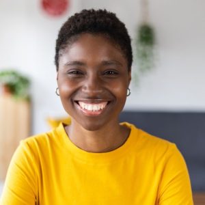 portrait-screen-view-of-smiling-millennial-african-woman-on-video-call-at-home-e1655156238810.jpg